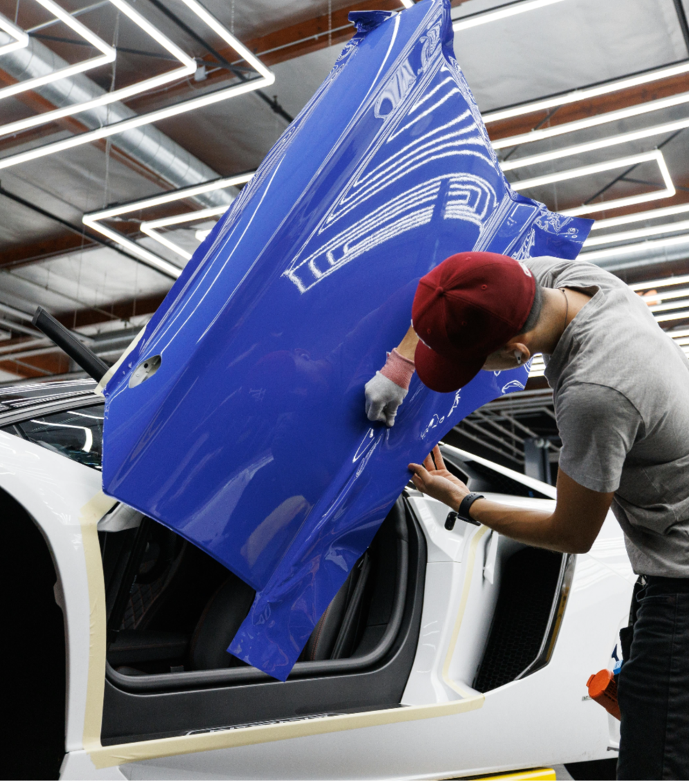 Vehicle wrap installer in a workshop