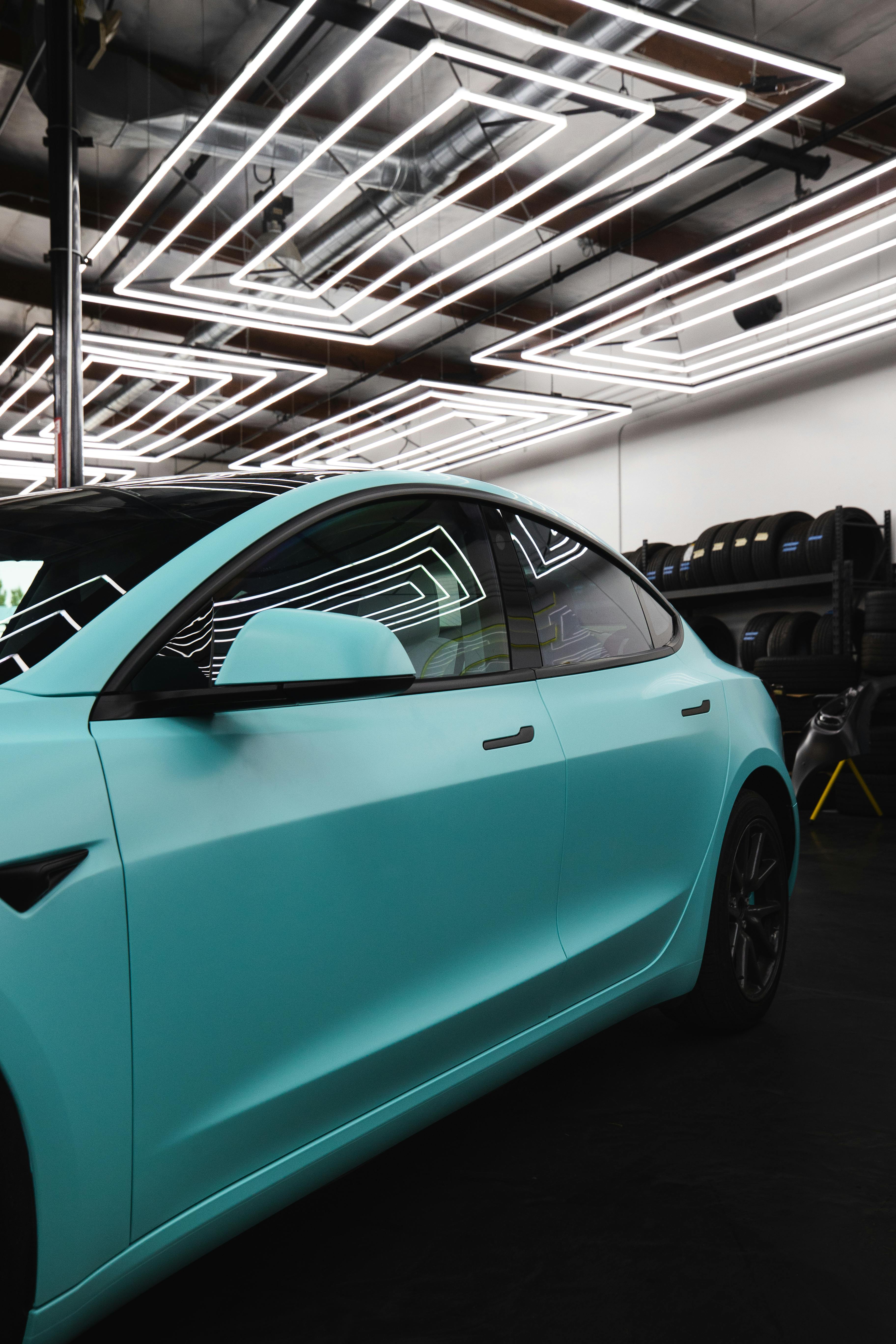 Bright blue colored vinyl wrap installed on a car