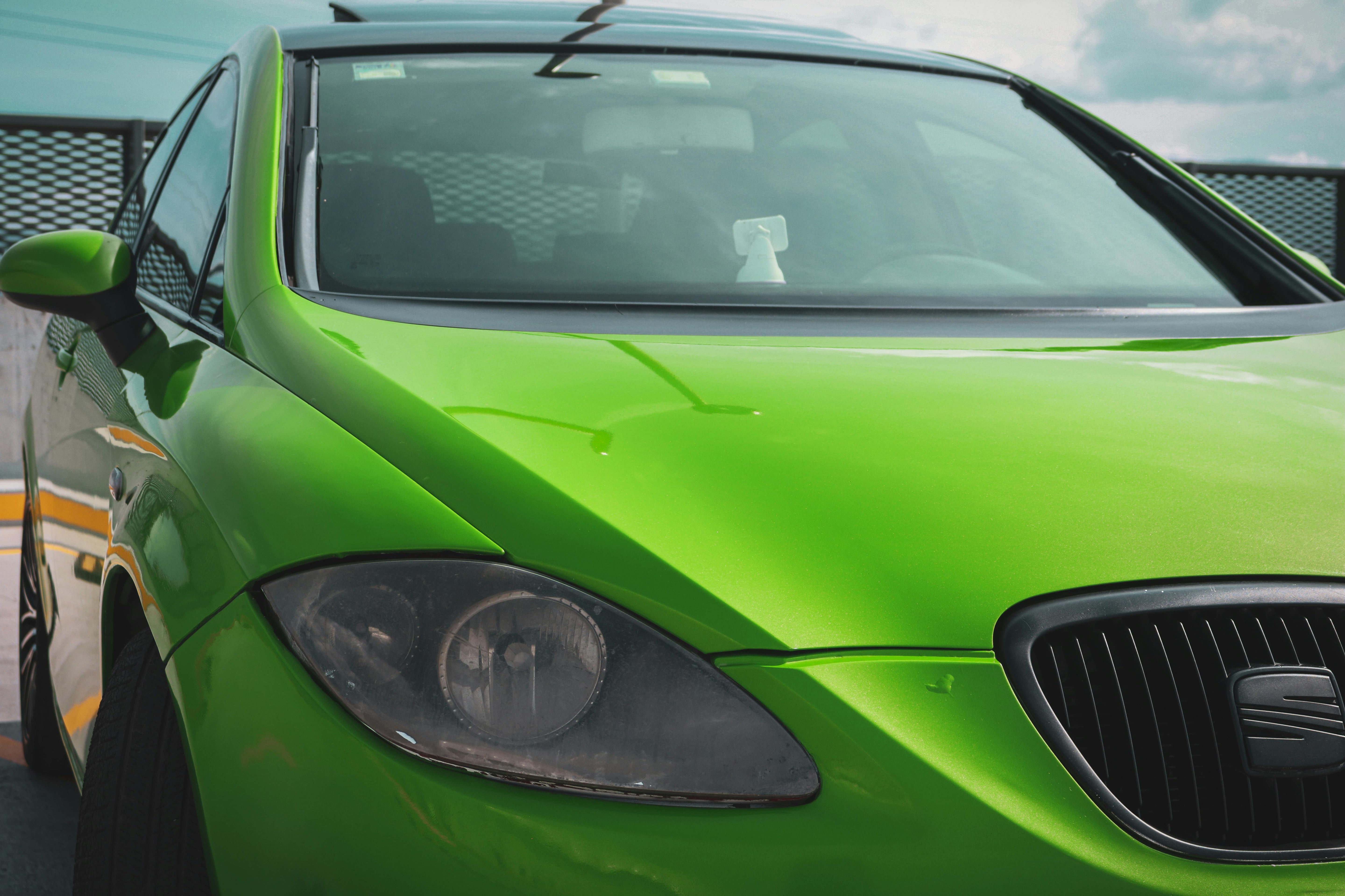 Headlight of a car with bright green vinyl wrap