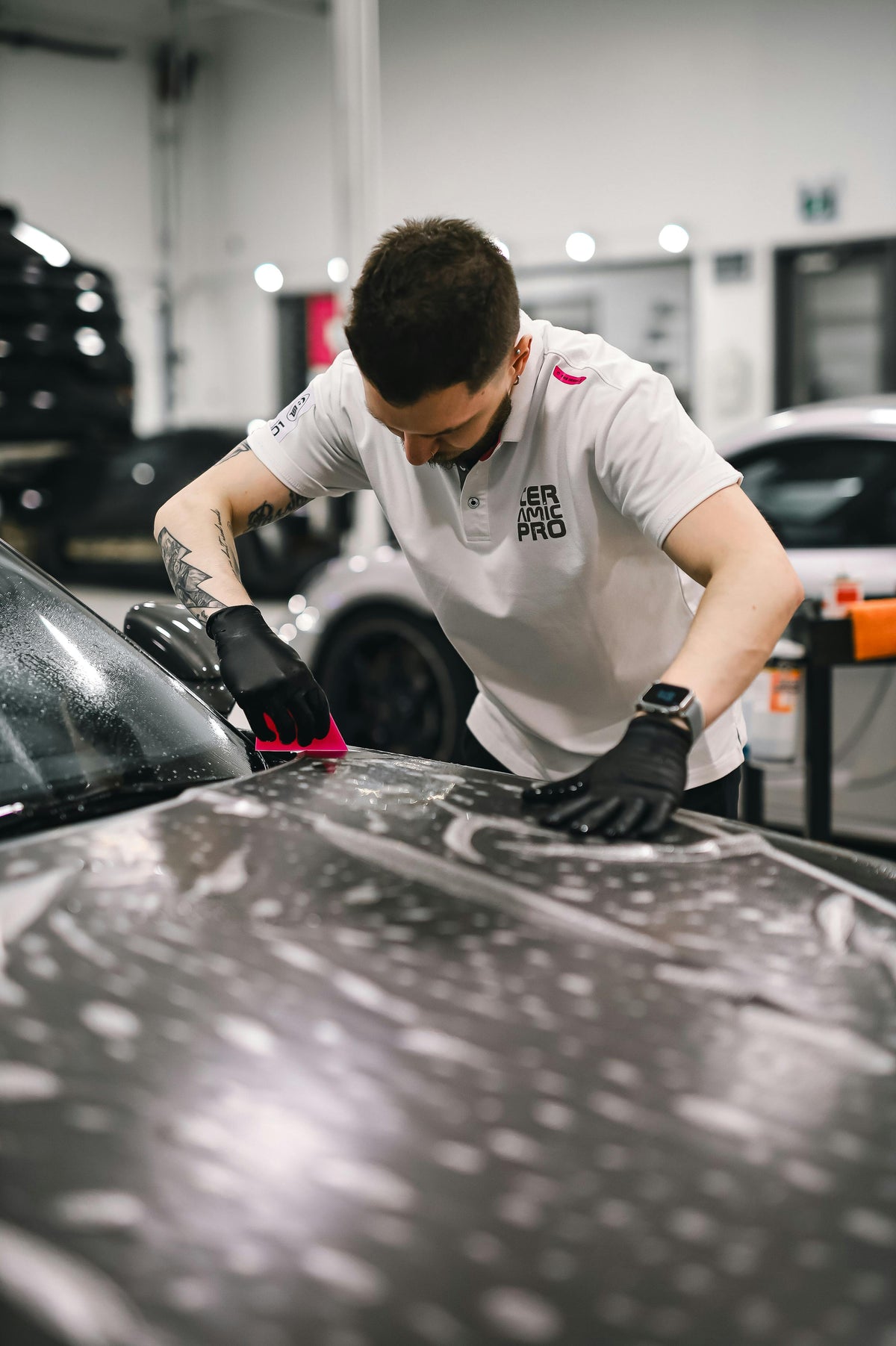 PPF installer working on vehicle paint protection film